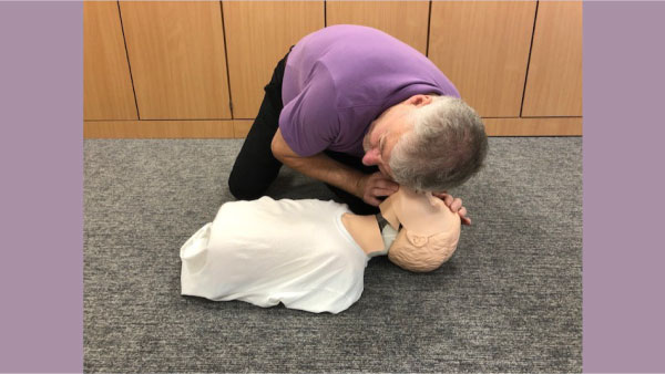 trainer-checking-for-breathing-on-child-600.jpg